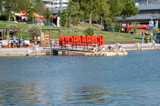 Vienna, Austria - August 10, 2022: The Viennese use them to relax, in bars and restaurants along the Old Danube or at Copa Beach and Sunken City on Danube Island.