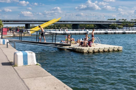 Vienna, Austria - August 10, 2022: The Viennese use them to relax, in bars and restaurants along the Old Danube or at Copa Beach and Sunken City on Danube Island.