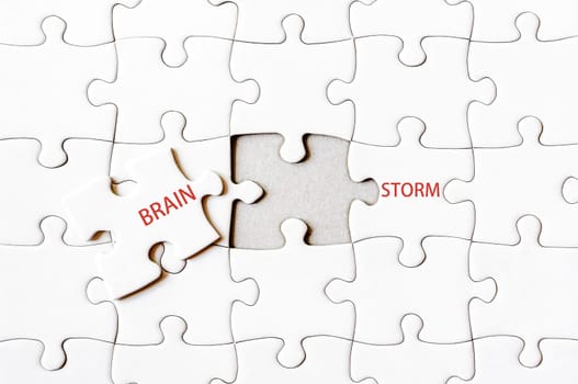 Missing jigsaw puzzle piece completing word BRAINSTORM. Business concept image for completing the final puzzle piece.