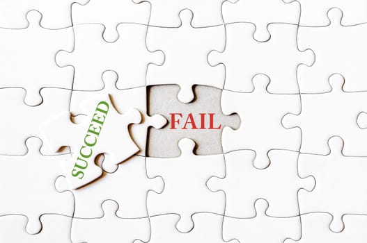 Missing jigsaw puzzle piece with word SUCCEED, covering text FAIL. Business concept image for completing the final puzzle piece.