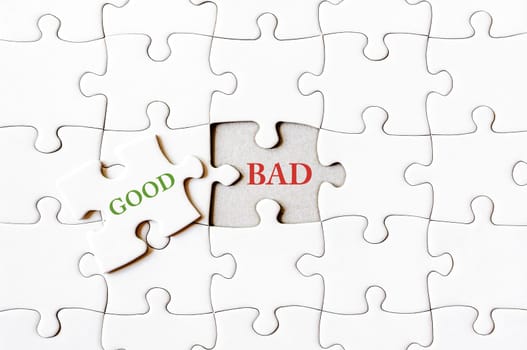 Missing jigsaw puzzle piece with word GOOD, covering text BAD. Business concept image for completing the final puzzle piece.