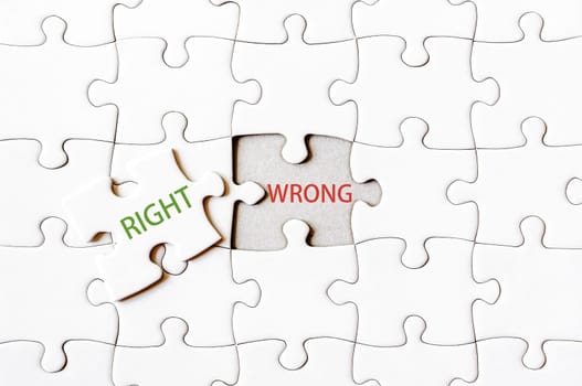 Missing jigsaw puzzle piece with word RIGHT, covering text WRONG. Business concept image for completing the final puzzle piece.