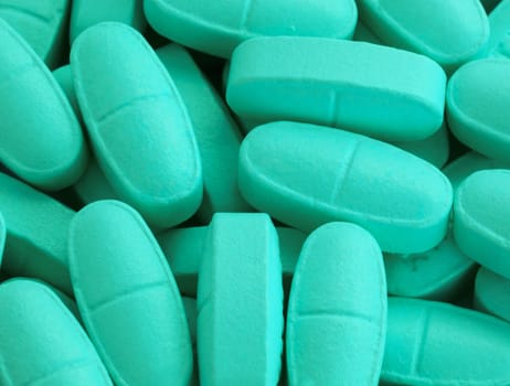 bunch of turquoise pills spilled on the table