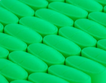 bunch of green pills spilled on the table