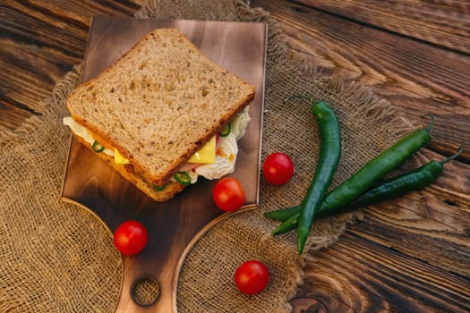 Country sandwich: Rye bread, ham, cheese, tomato and chilli with barbecue sauce