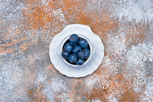 Top view of porcelain bowl with fresh  blueberry