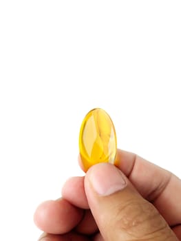 Hand holding omega 3 capsules on white background close up high definition product health care concept