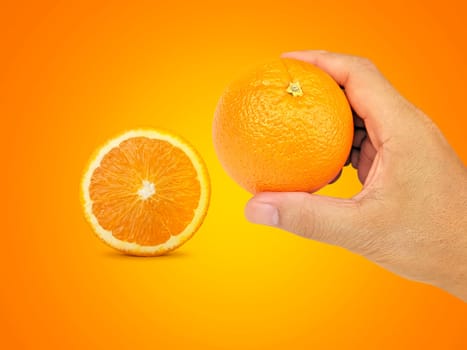 hand holding orange fruit and orange slices on orange background