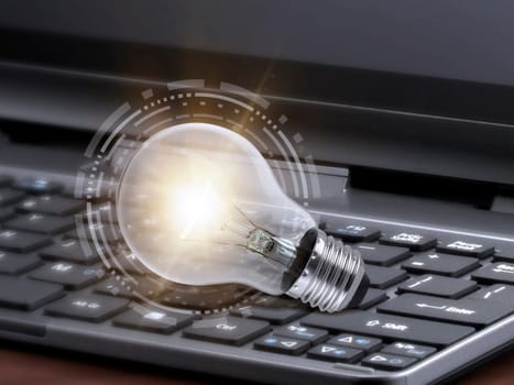 Laptop and glowing light bulb. Self learning or education knowledge and business studying concept. Idea of learning online or e-learning from home