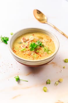 Delicious homemade leek soup with minced meat and chili on marble background