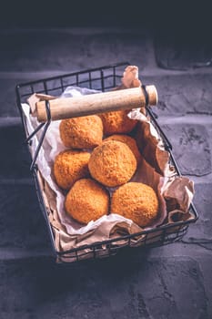 Homemade Arancini - deep fried rice balls stuffed with Mozzarella cheese in basket