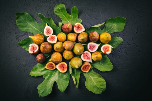 Harvesting - tasty organic figs on black background