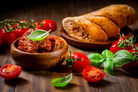Sun dried and pickled tomatoes with fresh herbs, spices and tomato ciabatta