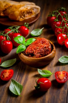 Sun dried and pickled tomatoes with fresh herbs, spices and tomato ciabatta