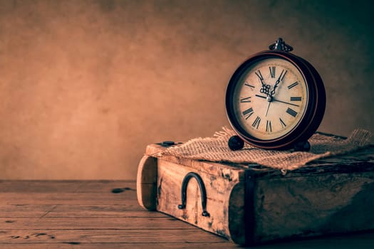 Vintage alarm clock with copy space. Photo in retro color image style