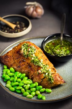 Grilled pork steak with edamame beans and Chimichurri sauce