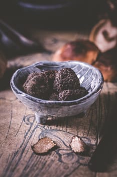 Truffles and shiitake mushrooms and spices on kitchen table