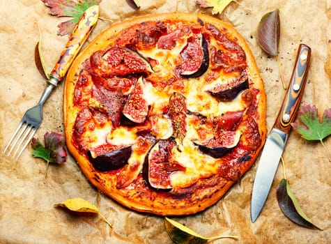 Pizza baked with meat and autumn figs