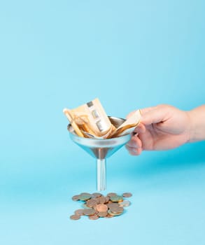 Inflation and financial crash, euro banknotes in a funnel become coins, economic development and increasing prices, worthless money