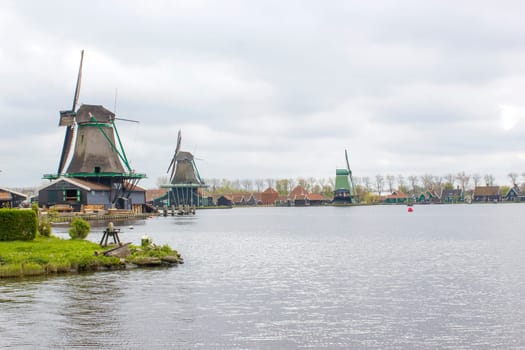 rural landscape with windmills at famous tourist site Zaanse Schans in the Netherlands