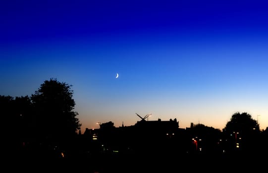Night amsterdam sky with the moon