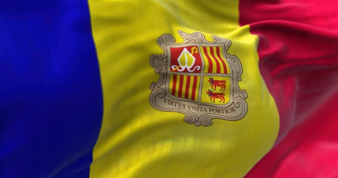 Close-up view of the andorran national flag waving in the wind. Andorra is a sovereign landlocked microstate on the Iberian Peninsula. Fabric textured background. Selective focus