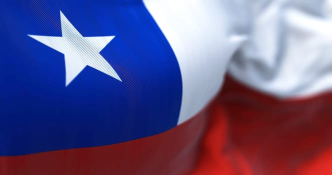 Close-up view of the Chile national flag waving in the wind. The Republic of Chile is a country in the western part of South America. Fabric textured background. Selective focus