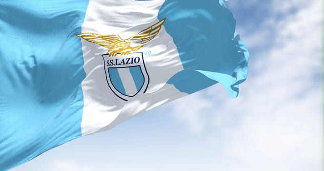 Rome, Italy, July 2022: Close up of the flag of SS Lazio waving. SS Lazio is a professional football club based in Rome. Fabric textured background. Selective focus
