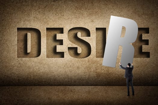 Concept of desire, asian business man with hold a word to fill the wall.