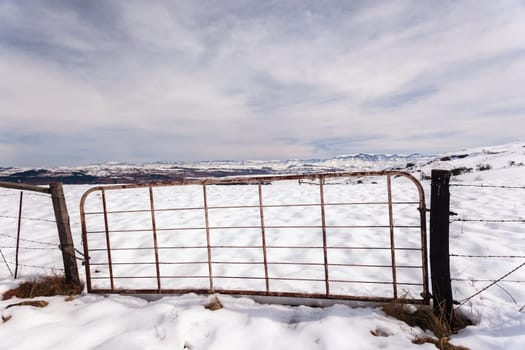 Gate fence in  high plateau mountain terrain in winter snow scenic landscape