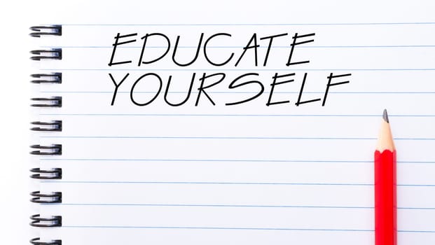 White blank  notebook page with red pencil on the right, with copy space available