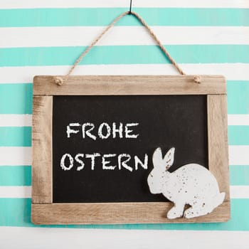 Rustic chalk tadel on striped background with Easter bunny
