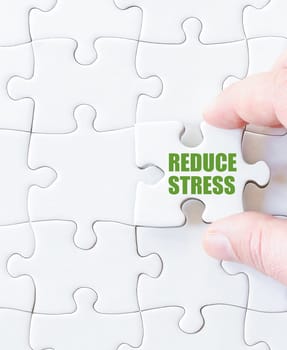 Missing jigsaw puzzle piece with words  REDUCE STRESS. Business concept image for completing the puzzle.