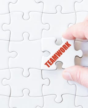 Missing jigsaw puzzle piece with word TEAMWORK. Business concept image for completing the puzzle.