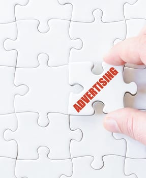 Missing jigsaw puzzle piece with word ADVERTISING. Business concept image for completing the puzzle.