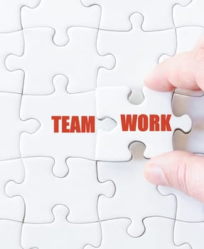 Missing jigsaw puzzle piece with word TEAMWORK. Business concept image for completing the puzzle.