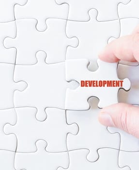Missing jigsaw puzzle piece with word DEVELOPMENT. Business concept image for completing the puzzle.