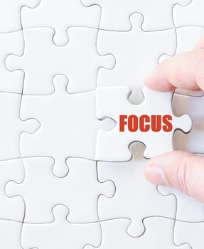 Missing jigsaw puzzle piece with word  FOCUS. Business concept image for completing the puzzle.