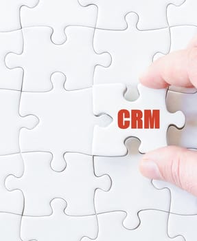 Missing jigsaw puzzle piece with word  CRM. Business concept image for completing the puzzle.