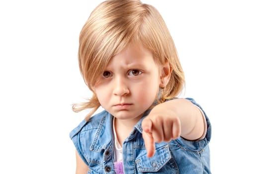 Portrait of a young angry girl pointing up