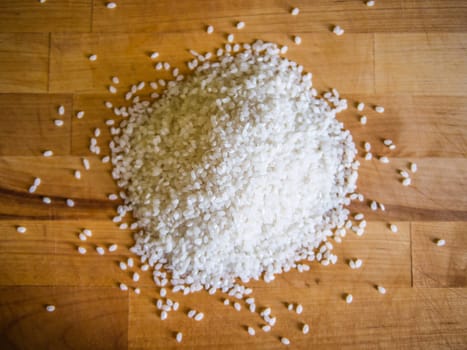 Pile of white rice on the wooden board