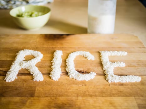 Rice word made of rice on wooden board
