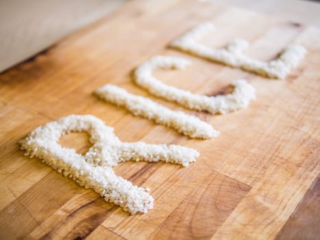 Rice word made of rice on wooden board