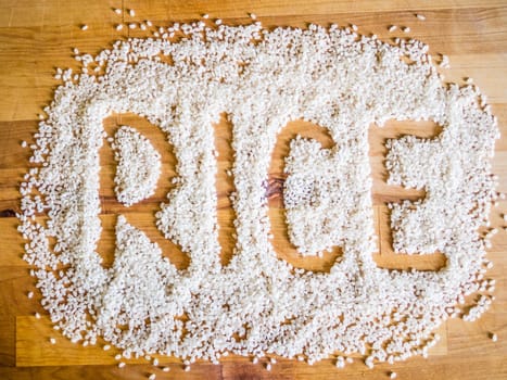 Rice word made of rice on wooden board