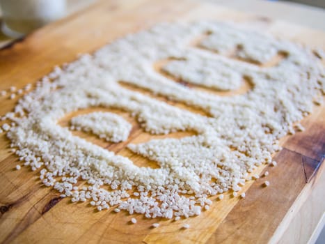 Rice word made of rice on wooden board
