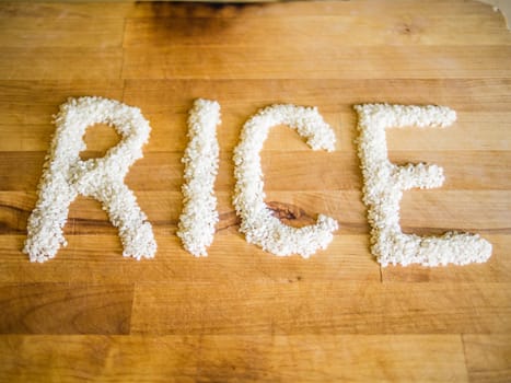 Rice word made of rice on wooden board