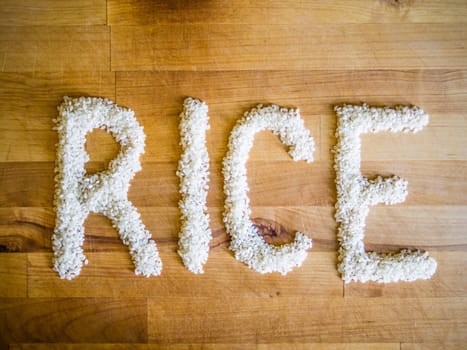 Rice word made of rice on wooden board