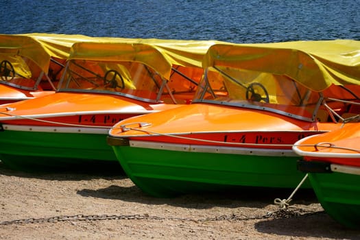 Detail view of pedal boats in a row at the shore of the Titisee