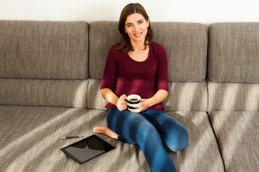 Beautiful woman at home drinking a cup pf tea
