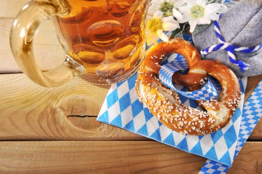 original Bavarian Laugenbrezel with Oktoberfest beer mug and traditional hat